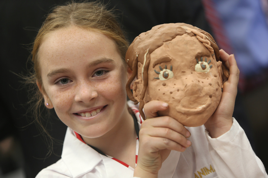 Student with clay model of herself in Garner Holt Education Through Imagination Animakerspace
